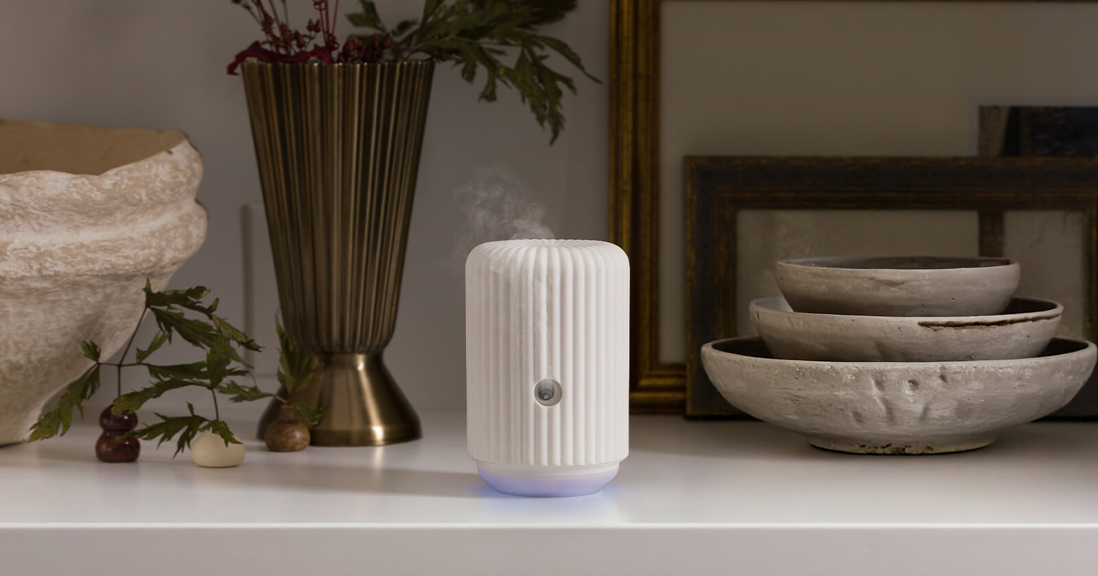 The Scentsy Solo diffusing fragrance on a styled mantel
